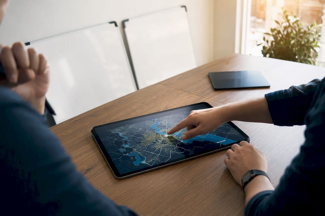 Hands pointing at a location website architecture map
