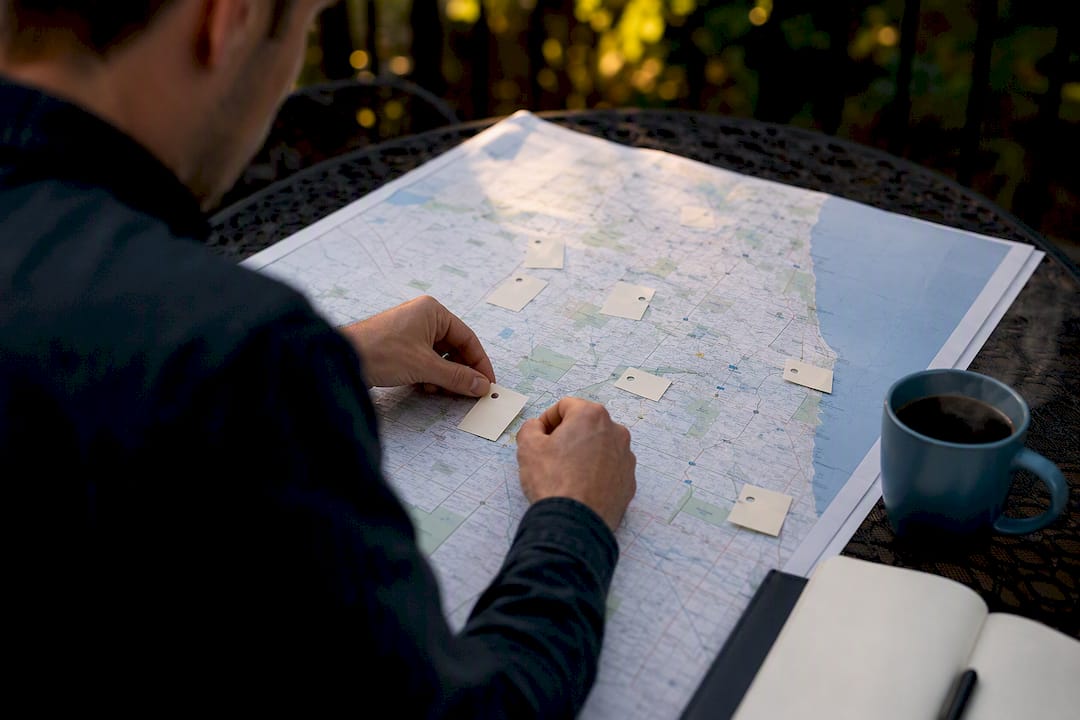 Hands organizing local service area map on desk