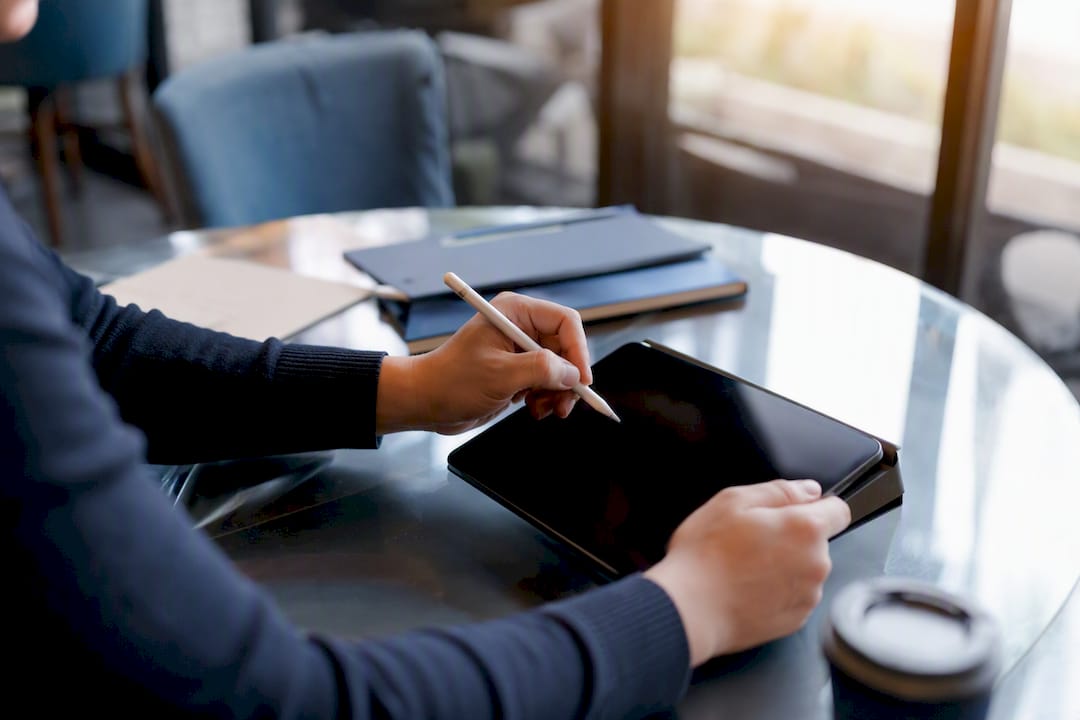 Hands scheduling social media posts on phone