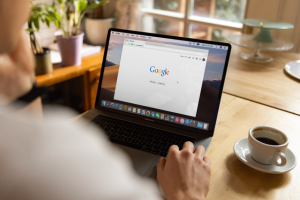 business owner analyzing Google search engine results on laptop